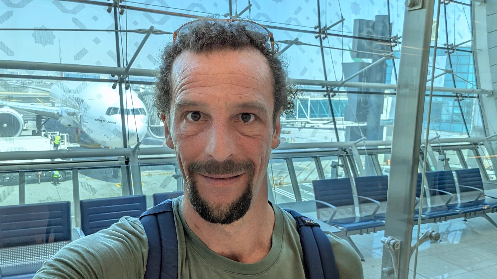 Selfie at DXB Gate F17 with the Emirates Boeing 777-300ER waiting outside